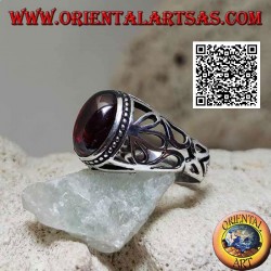 Silver ring with oval cabochon garnet on a setting with large floral openwork