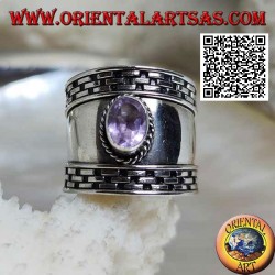 Wide band silver ring with oval faceted amethyst and hatching on the edges