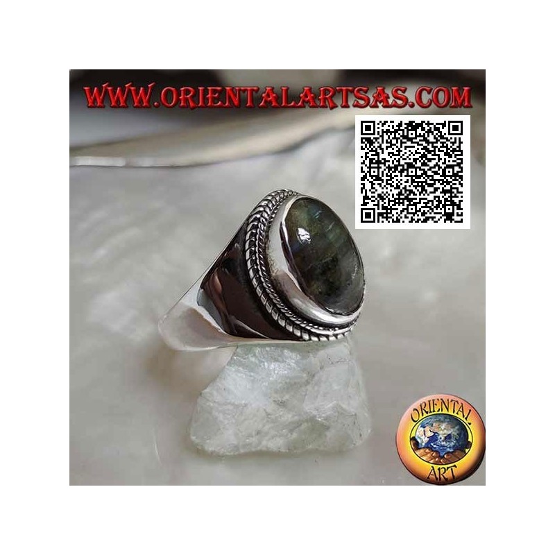 Silver band ring with oval labradorite surrounded by interweaving on a smooth setting