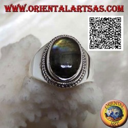 Silver band ring with oval labradorite surrounded by interweaving on a smooth setting