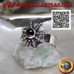 Silver ring in the shape of a pagoda umbrella with a central round garnet