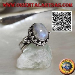 Silver ring with oval rainbow moonstone surrounded by trio of discs and intertwining