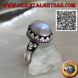 Silver ring with oval rainbow moonstone surrounded by trio of discs and intertwining