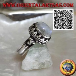 Silver ring with oval rainbow moonstone surrounded by trio of discs and intertwining