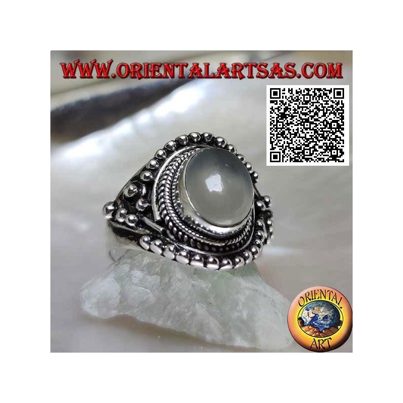 Silver ring with oval moonstone on ethnic setting decorated with intertwining and balls