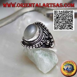 Silver ring with oval moonstone on ethnic setting decorated with intertwining and balls