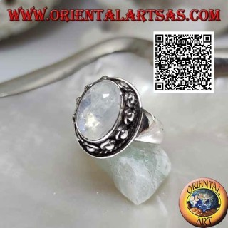 Silver ring with oval moonstone surrounded by interweaving and ball in the donut
