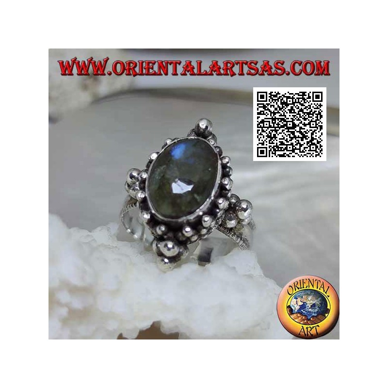 Silver ring with oval cabochon labradorite on a setting decorated with balls