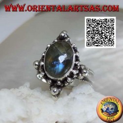 Silver ring with oval cabochon labradorite on a setting decorated with balls