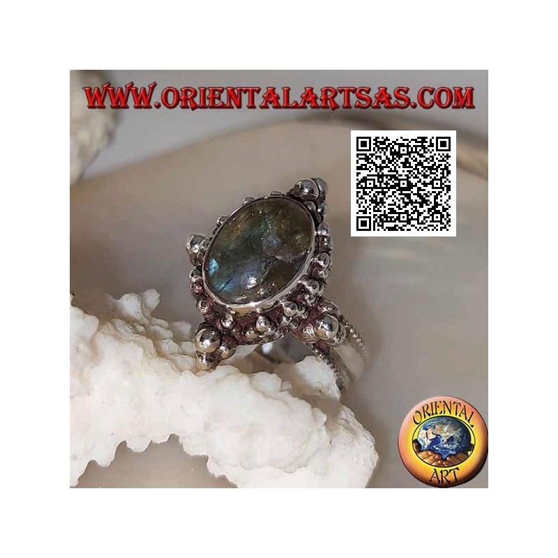 Silver ring with oval cabochon labradorite on a setting decorated with balls