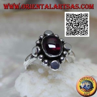Silver ring with oval cabochon garnet surrounded by alternating studs and balls