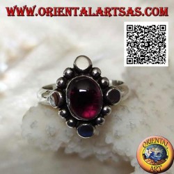 Silver ring with oval cabochon garnet surrounded by alternating studs and balls