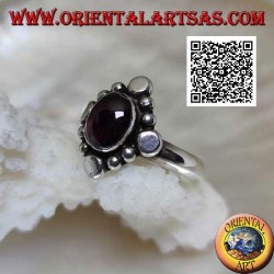 Silver ring with oval cabochon garnet surrounded by alternating studs and balls