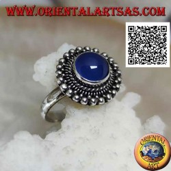 Silver ring with cabochon round blue agate surrounded by interlacing and balls