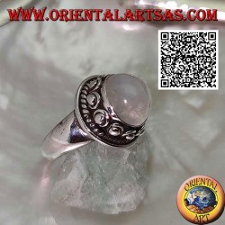 Silver ring with round moonstone surrounded by interweaving and ball in the donut