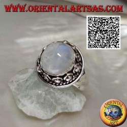 Silver ring with round moonstone surrounded by interweaving and ball in the donut