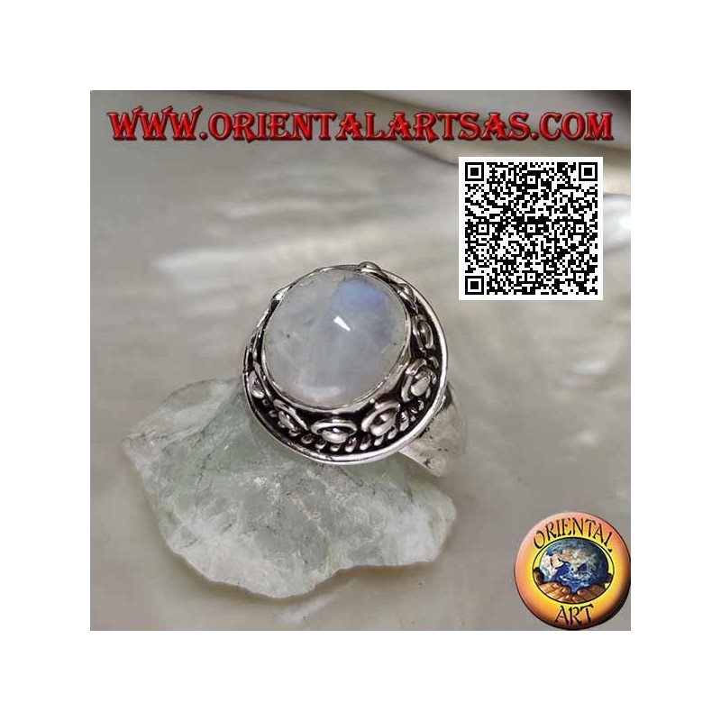 Silver ring with round moonstone surrounded by interweaving and ball in the donut