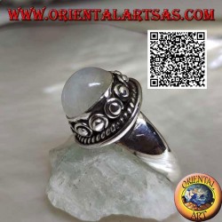 Silver ring with round moonstone surrounded by interweaving and ball in the donut