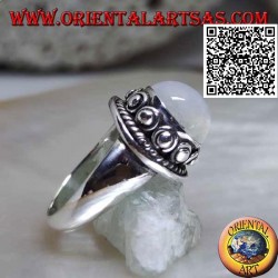 Silver ring with round moonstone surrounded by interweaving and ball in the donut