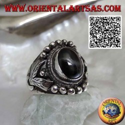 Silver ring with oval black star on ethnic setting with balls and leaves on the sides