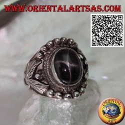 Silver ring with oval black star on ethnic setting with balls and leaves on the sides