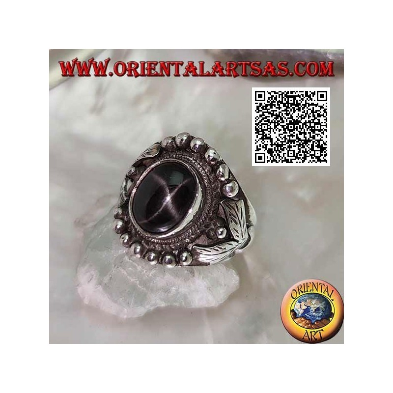Silver ring with oval black star on ethnic setting with balls and leaves on the sides