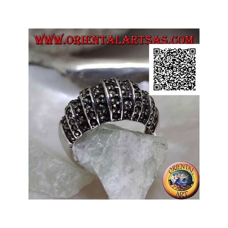 Silver ring with a rounded band on the front cut by vertical lines and studded with marcasite