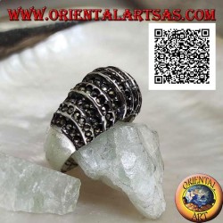 Silver ring with a rounded band on the front cut by vertical lines and studded with marcasite