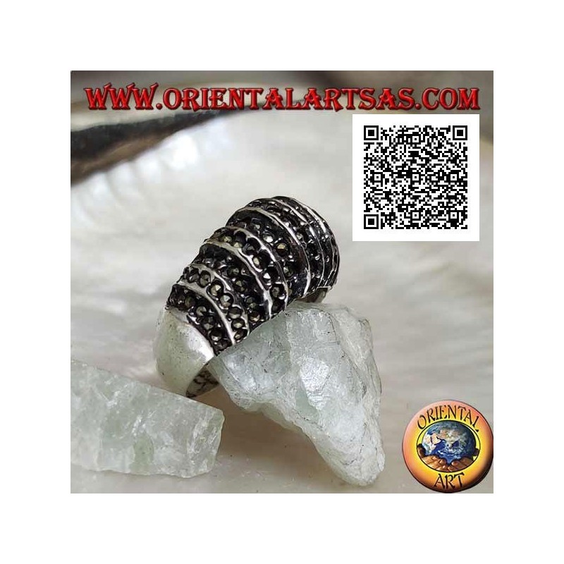 Silver ring with a rounded band on the front cut by vertical lines and studded with marcasite