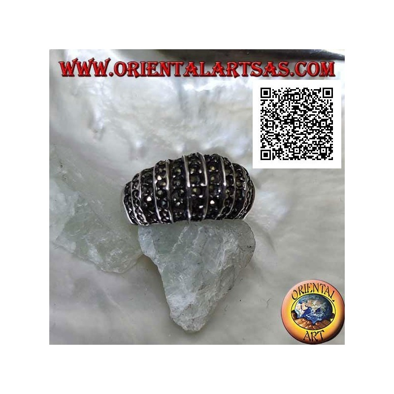 Silver ring with a rounded band on the front cut by vertical lines and studded with marcasite