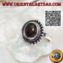 Silver ring with oval labradorite surrounded by intertwining and balls only on one half