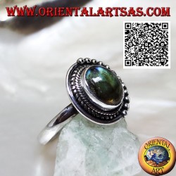 Silver ring with oval labradorite surrounded by intertwining and balls only on one half