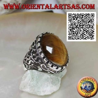 Silver ring with large cabochon oval tiger eye surrounded by mystical bas-relief decorations
