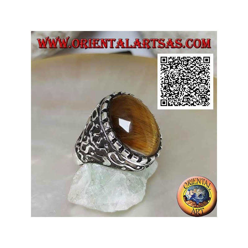 Silver ring with large cabochon oval tiger eye surrounded by mystical bas-relief decorations
