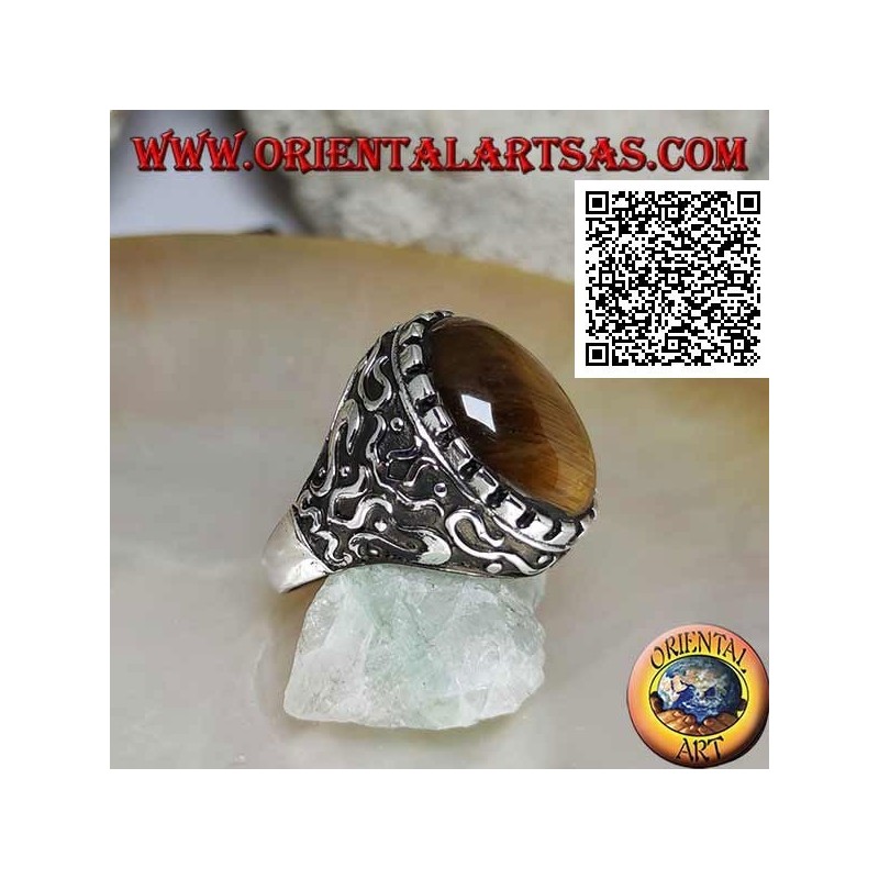 Silver ring with large cabochon oval tiger eye surrounded by mystical bas-relief decorations