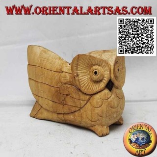 Sculpture of a three-quarter owl with an outstretched wing in hibiscus wood