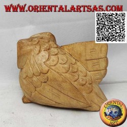 Sculpture of a three-quarter owl with an outstretched wing in hibiscus wood