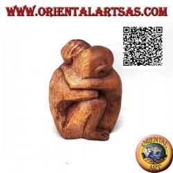 10 cm sculpture of a couple in consoling embrace in suar wood