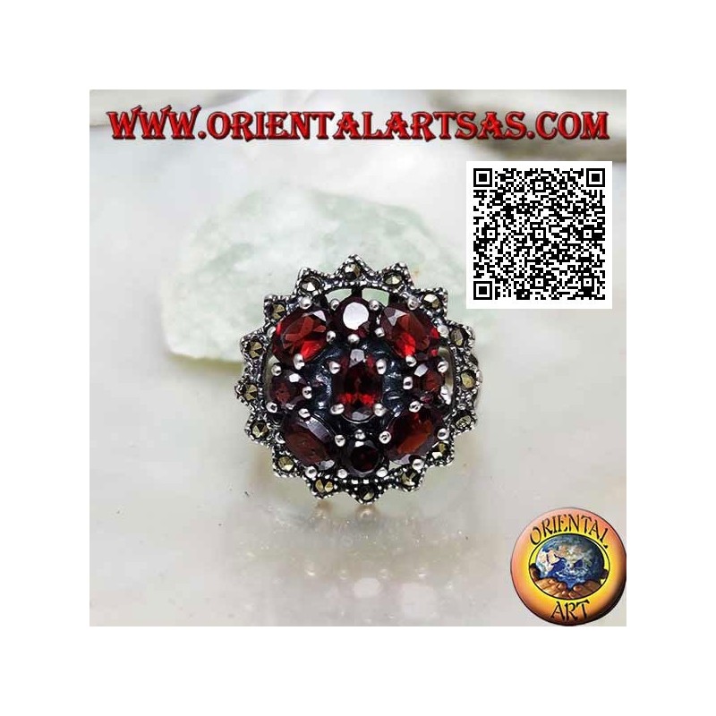 Silver ring with oval garnet surrounded by round and oval garnets in a sun of marcasite
