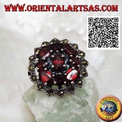 Silver ring with oval garnet surrounded by round and oval garnets in a sun of marcasite