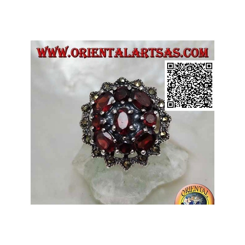 Silver ring with oval garnet surrounded by round and oval garnets in a sun of marcasite