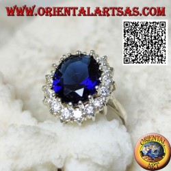Silver ring with oval faceted synthetic sapphire set surrounded by white zircons
