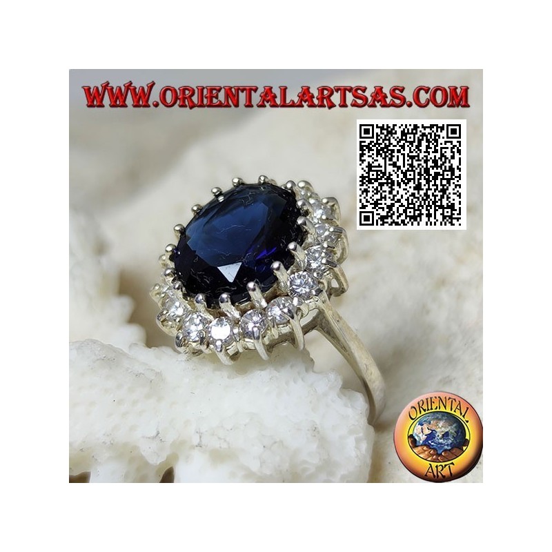 Silver ring with oval faceted synthetic sapphire set surrounded by white zircons