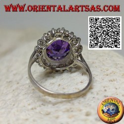 Silver ring with faceted oval synthetic amethyst set surrounded by white zircons