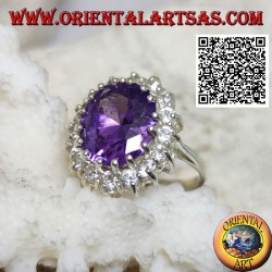 Silver ring with faceted oval synthetic amethyst set surrounded by white zircons