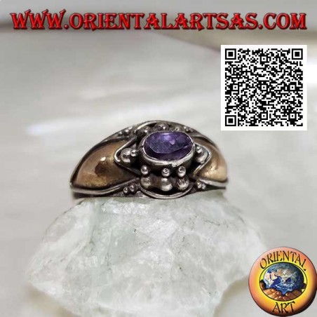 Silver ring with horizontal oval amethyst with balls above and below and 14 karat gold plates on the sides