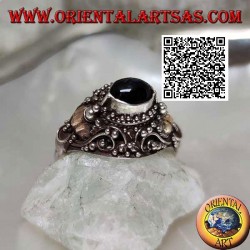 Silver ring with a raised horizontal oval onyx on ethnic setting with 14 carat gold leaves