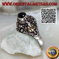 Silver ring with a raised horizontal oval onyx on ethnic setting with 14 carat gold leaves