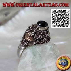 Silver ring with a raised horizontal oval onyx on ethnic setting with 14 carat gold leaves