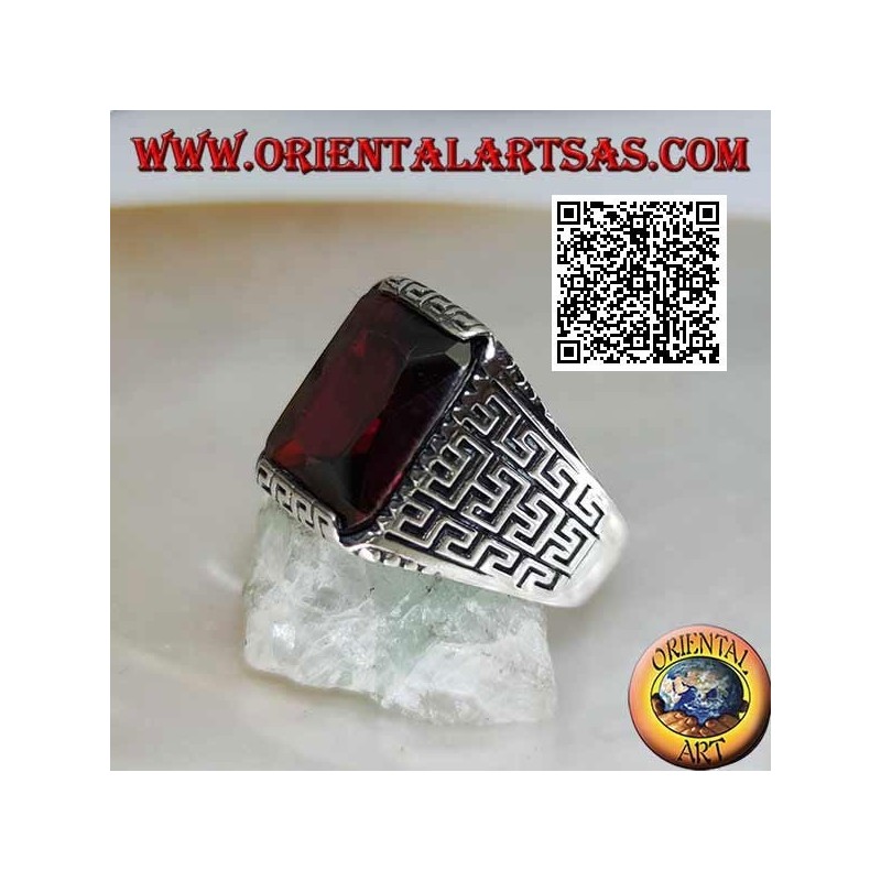 Silver ring with faceted rectangular garnet and geometric labyrinth engraved on the sides